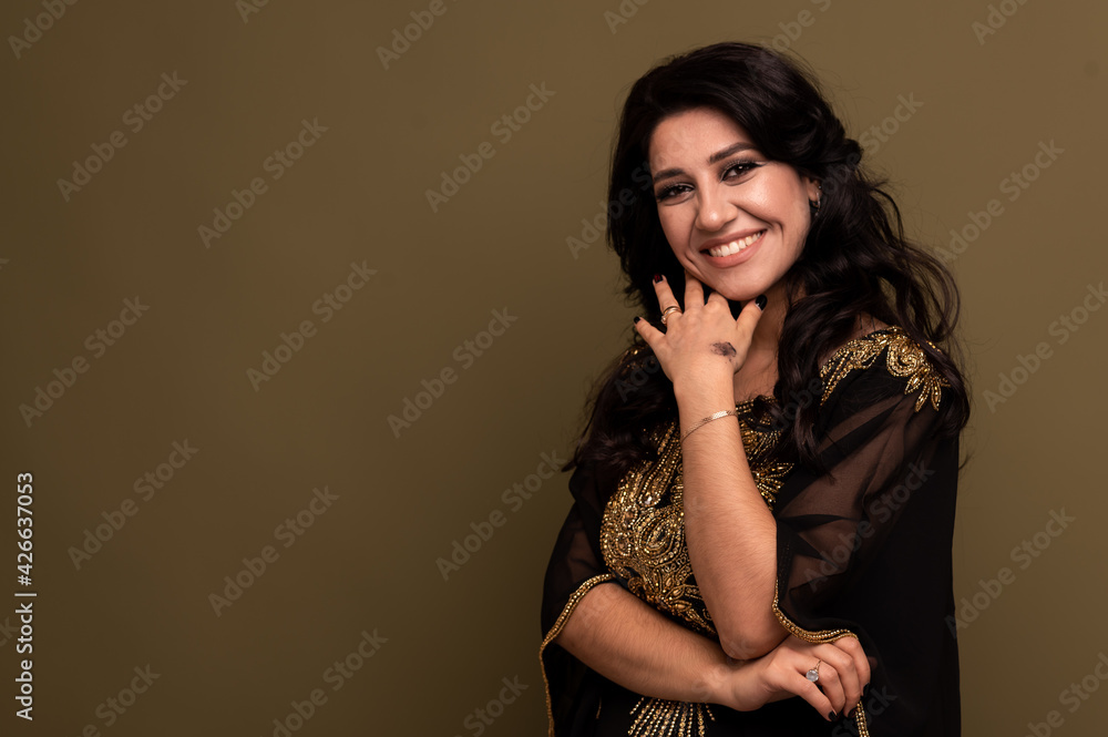 Portrait of beautiful smiling young muslim arabian woman looking at camera, copy space Portrait of beautiful smiling young muslim arabian woman looking at camera, copy space