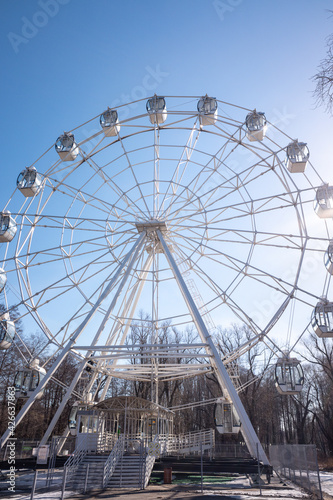 Ferris wheel in the park against the blue sky