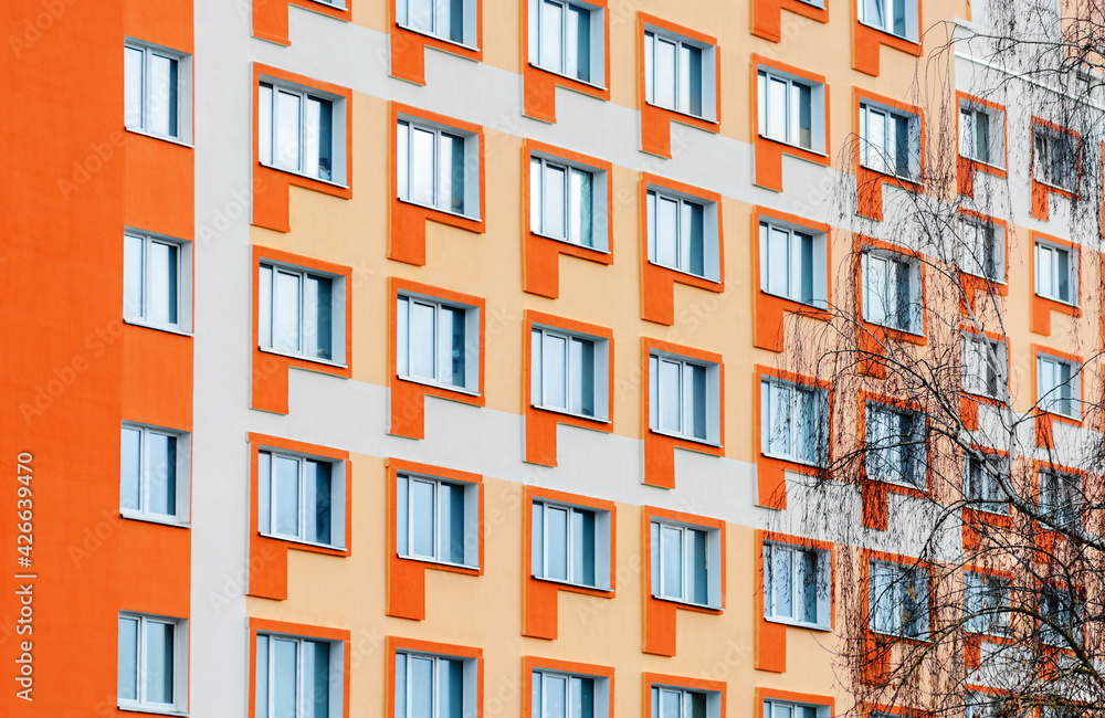 Wall with windows in an apartment building. Windows of a multi-storey building
