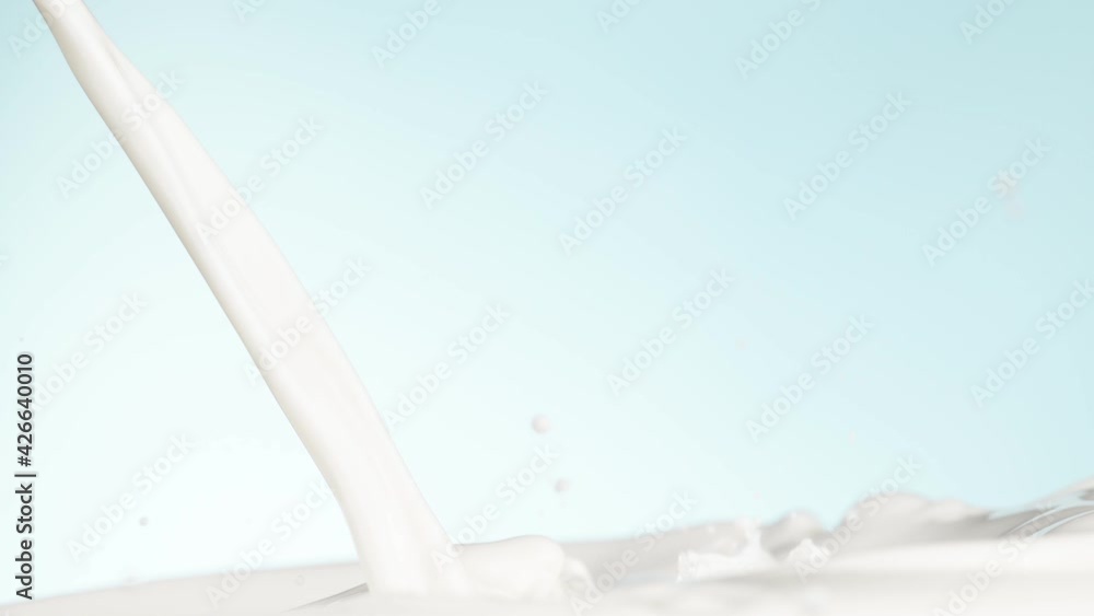 Super slow motion of pouring milk on soft blue background. Filmed on high speed cinema camera, 1000 fps. Super slow motion of pouring milk on soft blue background. Filmed on high speed cinema camera, 1000 fps.