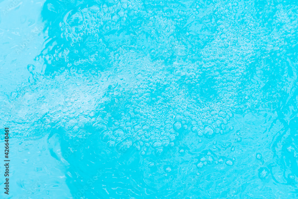 Bubbling water background of a blue swimming pool