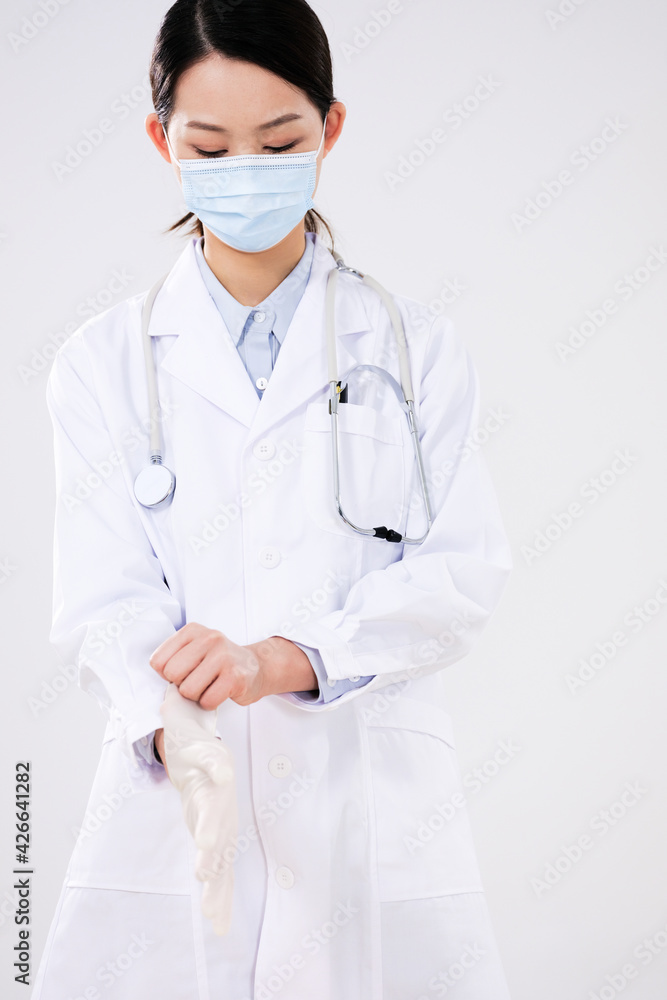  a female doctor wearing surgical gloves