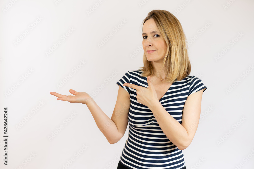 Young woman over isolated white background pointing finger to the side Young woman over isolated white background pointing finger to the side
