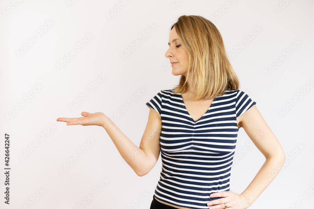 Photo portrait of smiling woman holding blank space on hand isolated over white background. Photo portrait of smiling woman holding blank space on hand isolated over white background.