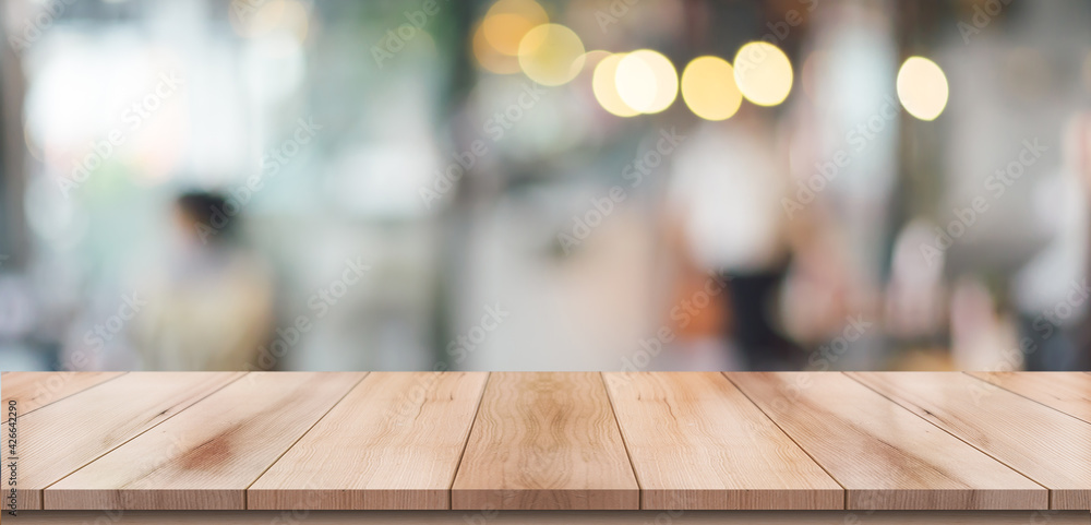 Empty wooden table top with lights bokeh on blur restaurant background. Empty wooden table top with lights bokeh on blur restaurant background.