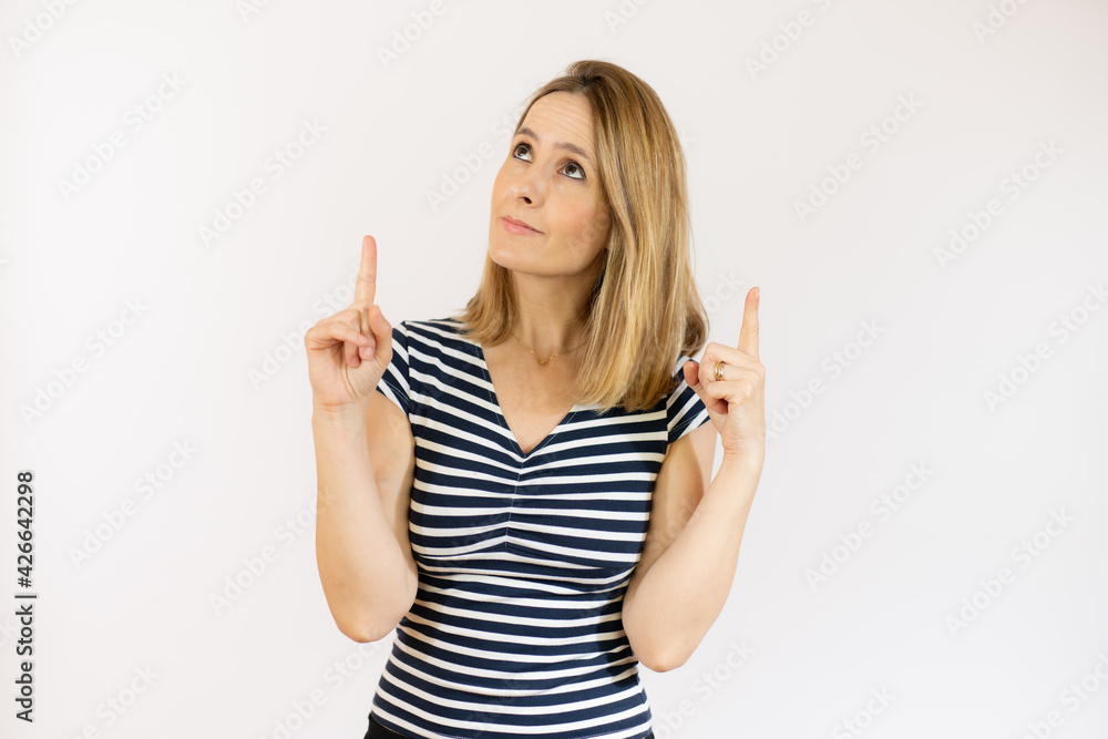 Portrait of beautiful young woman pointing up over white background. Portrait of beautiful young woman pointing up over white background.