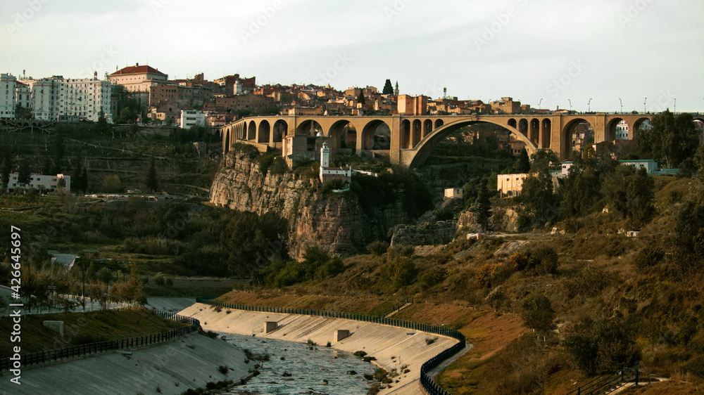 Fototapeta premium CONSTANTINE, ALGERIA - View of stone bridges and old houses on the cliff at Constantine, Algeria. Panorama of Constantine city, Algeria 