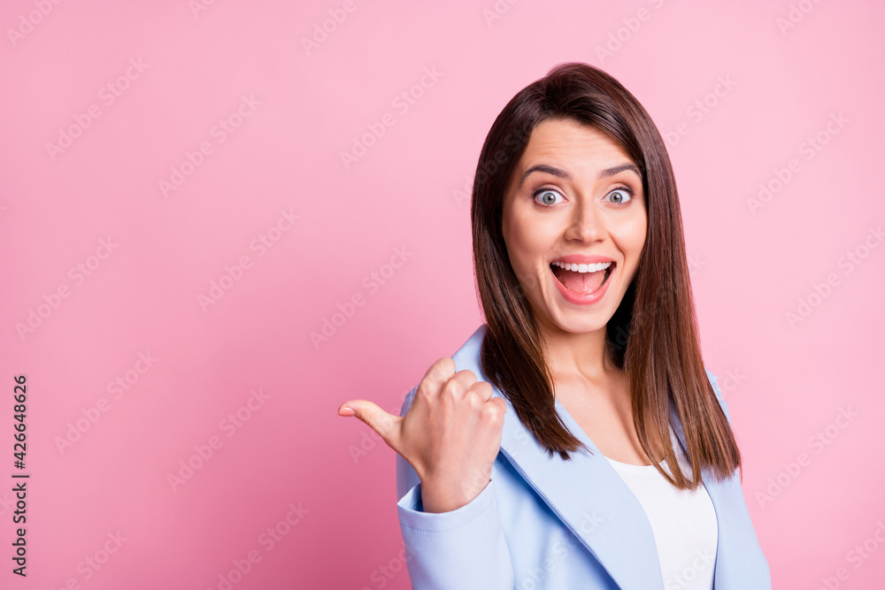 Portrait of young beautiful smiling positive excited businesswoman point finger copyspace isolated on pink color background Portrait of young beautiful smiling positive excited businesswoman point finger copyspace isolated on pink color background