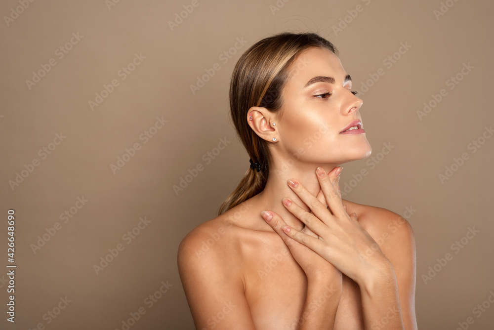 Lovely young woman touches her neck. Beautiful woman cares for the skin neck. heath and beauty concept Lovely young woman touches her neck. Beautiful woman cares for the skin neck. heath and beauty concept