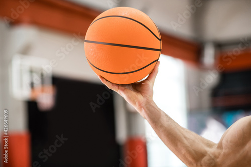 Close up picture of a mans hand with a ball