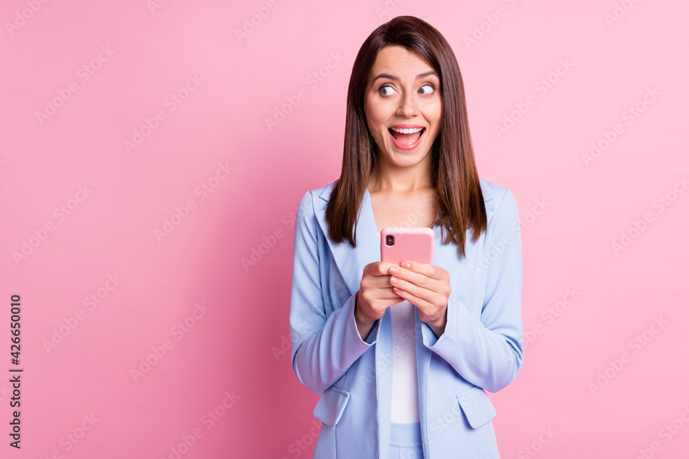 Photo of young excited dreamy girl use smartphone happy smile chat type isolated over pink color background Photo of young excited dreamy girl use smartphone happy smile chat type isolated over pink color background