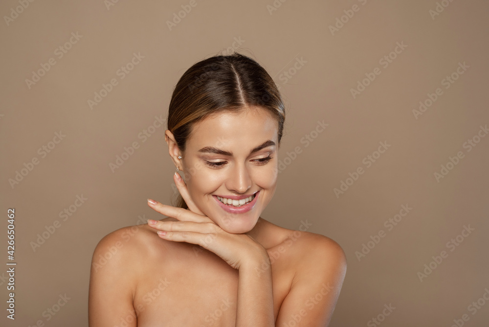 Beautiful Caucasian young woman with perfect skin touching face Beautiful Caucasian young woman with perfect skin touching face