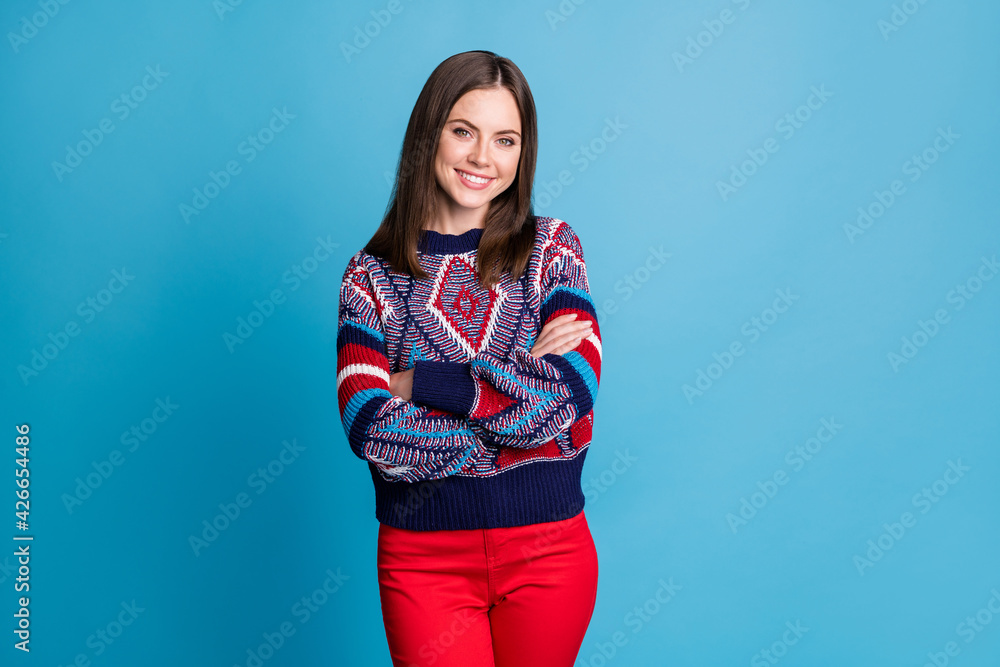 Photo of young cheerful woman happy positive smile confident folded hands isolated over blue color background Photo of young cheerful woman happy positive smile confident folded hands isolated over blue color background