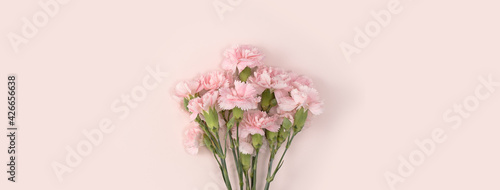 Design concept of Mother's day holiday greeting with carnation bouquet on pink table background