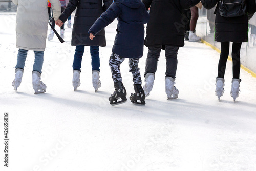 Many people ride on an artificial ice rink in the middle of the city.