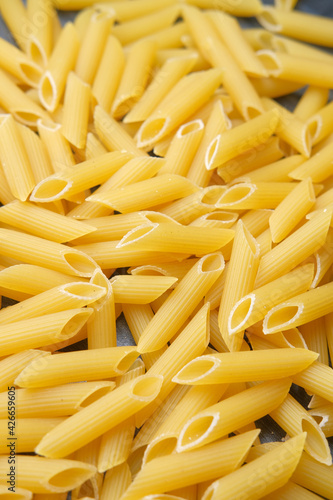 Variety of types and shapes of dry Italian pasta in a bowl.