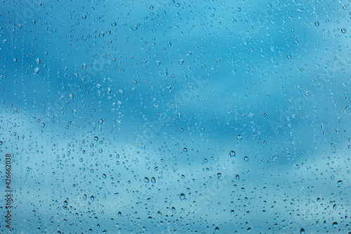Raindrops on the transparent window pane. Background of raindrops.