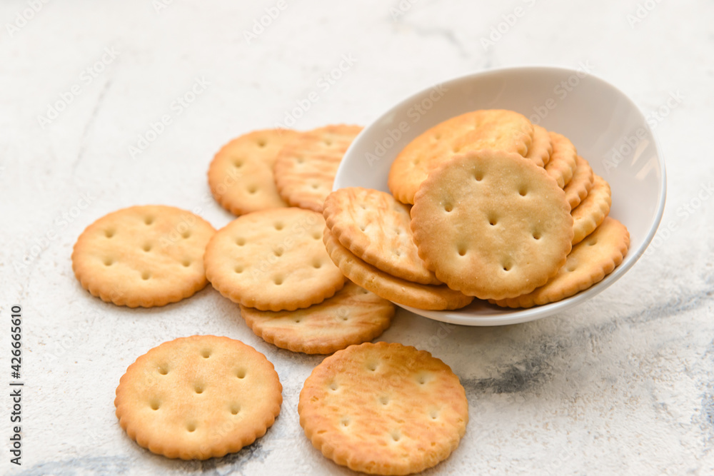 Bowl of crackers on light background