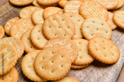 Tasty crackers on wooden background, closeup