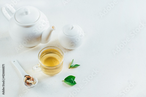 .tea service with tea in a transparent cup on a white background with free space