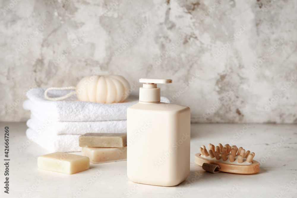 Bottle of shower gel and bath supplies on light background Bottle of shower gel and bath supplies on light background