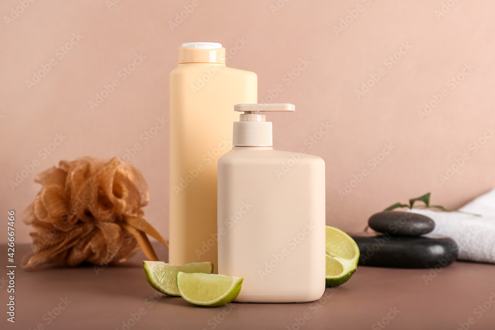 Shower gels and lime slices on color background Shower gels and lime slices on color background