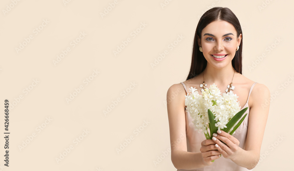 Beautiful young woman with hyacinth flowers on light background Beautiful young woman with hyacinth flowers on light background