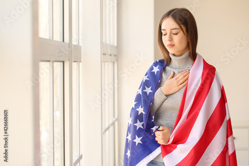 Sad young woman with USA fl...