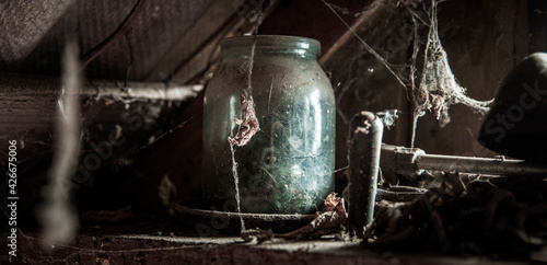 dusty glass with cobwebs in an old abandoned house