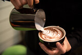 Barista make latte art focus in milk and coffee in vintage color tone.