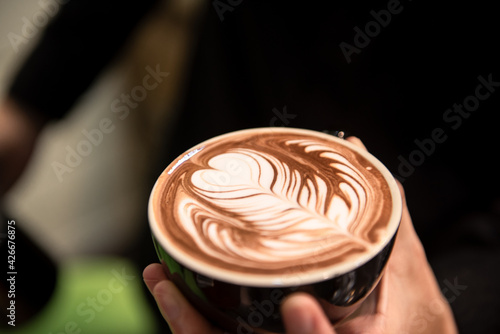 Barista make latte art focus in milk and coffee in vintage color tone.