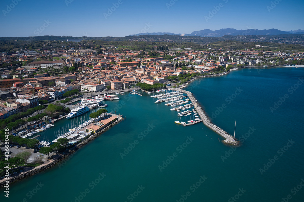 Aerial view of the coastline of the city of Desenzano del Garda on Lake Garda, Italy. Aerial panorama of Italian cities. Desenzano del garda port.