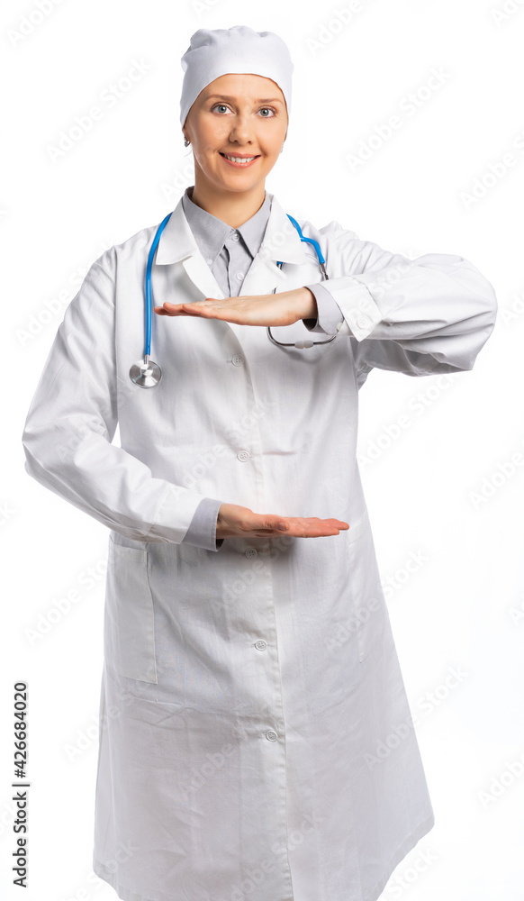 female doctor in a white coat and hat. the medic holds his hands in front of him parallel, smiles and looks at us. place for an inscription. white background, isolated female doctor in a white coat and hat. the medic holds his hands in front of him parallel, smiles and looks at us. place for an inscription. white background, isolated