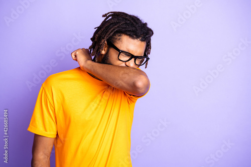 Portrait of nice sick brunet guy sneeze wear spectacles orange t-shirt isolated on vibrant lilac color background photo