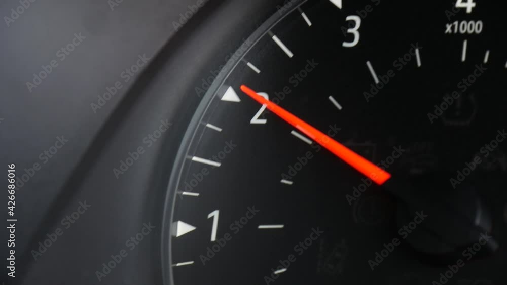 Closeup of the tachometer, RPMS gauge on the dash of a car as the