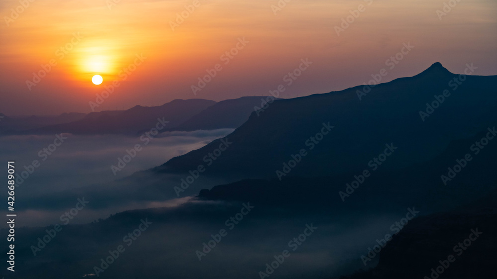 The magical sunrise with clouds and mountain 