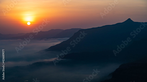 The magical sunrise with clouds and mountain 