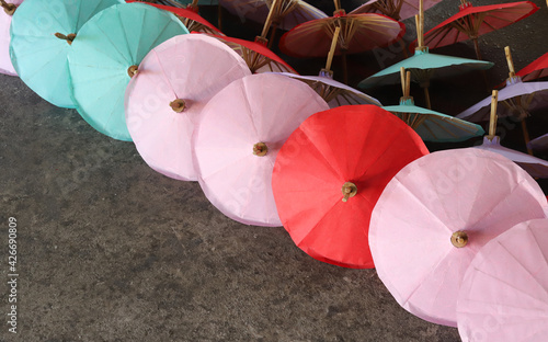 Closeup of colorful handmade paper umbrellas showing on the floor. 
