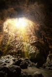 sunlight shine from cave roof illuminate the chamber at Khaoluang, Phetchaburi Province, Thailand.