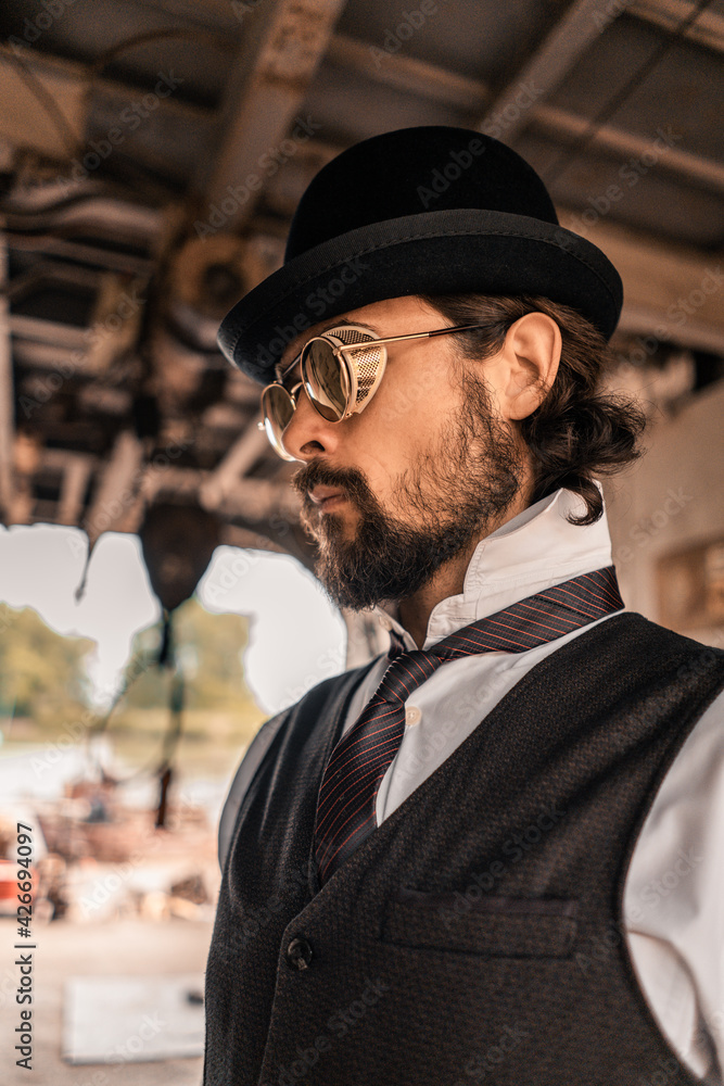 Steampunk. A hero on a river barge surrounded by steel mechanisms. A man with a weapon. Steampunk. A hero on a river barge surrounded by steel mechanisms. A man with a weapon.