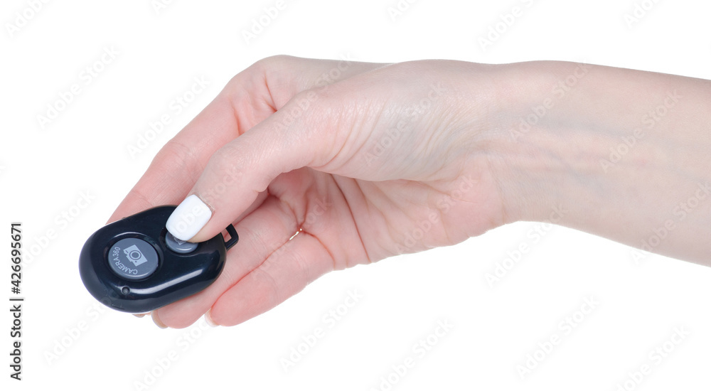 Shutter release button remote control for the camera in hand on white background isolation Shutter release button remote control for the camera in hand on white background isolation