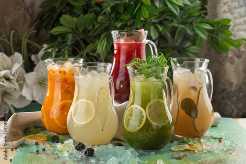 five pitcher with colorful lemonade on the table