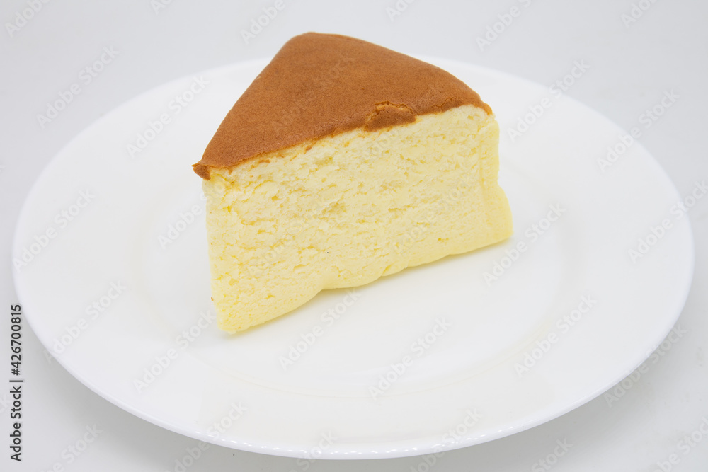 Slice of Japanese Style Fluffy Cheesecake on a White Plate Slice of Japanese Style Fluffy Cheesecake on a White Plate