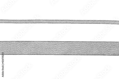 narrow and wide silver lurex ribbon on white background