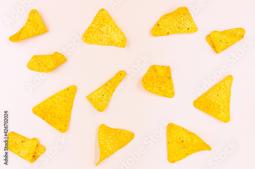 Top view Corn chips into a glass bowl, nachos isolated on orange background