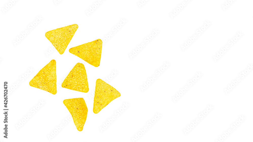 Corn chips into a glass bowl, nachos isolated on white background with copy space Corn chips into a glass bowl, nachos isolated on white background with copy space