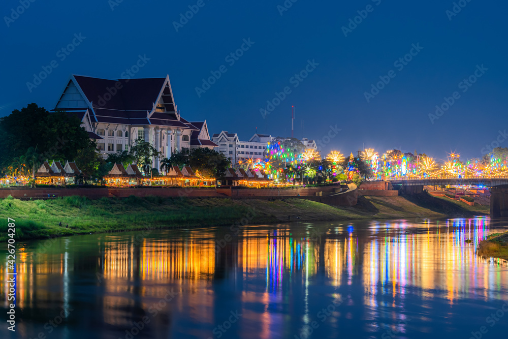 Beautiful light on the Nan River at night on the bridge (Naresuan Bridge) on the Road in Realm for Naresuan the Great Festival and Red Cross Annual event in Phitsanulok,Thailand.