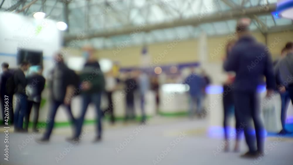 Modern city life. Abstract blurred background on business theme. Blurry defocused video. Unrecognizable people in a large modern building.