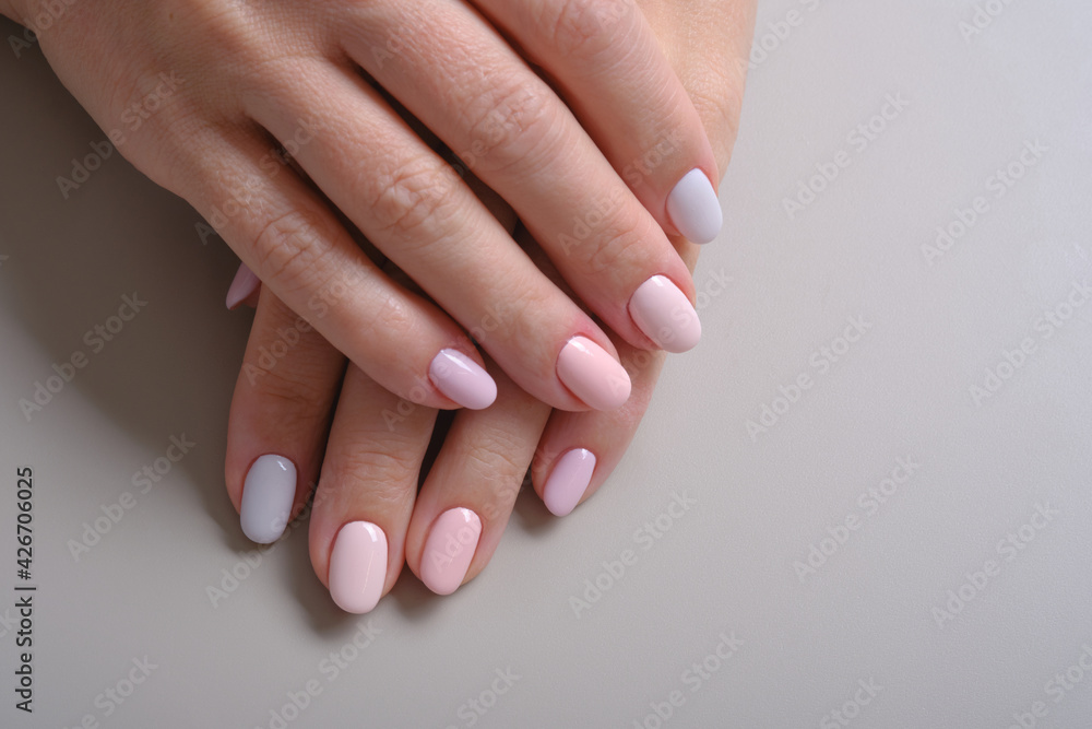 Hands with French manicure. Close Up Of Woman Fingers With Nail Art. Hands with pink and blue nail polish on a gray background. Selective focus
Hands with French manicure. Close Up Of Woman Fingers With Nail Art. Hands with pink and blue nail polish on a gray background. Selective focus