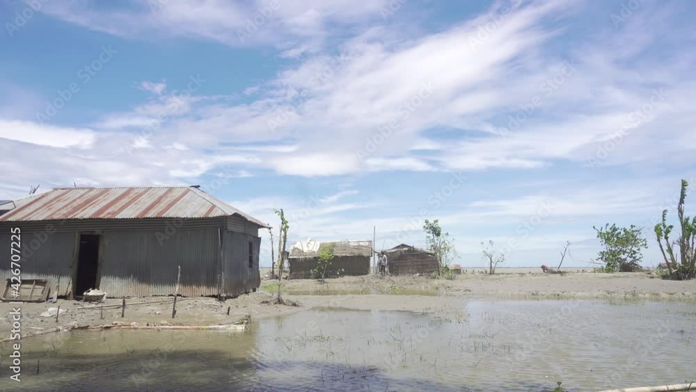 Wide view of a riverside house with a swamp after the flood. Wide view of a riverside house with a swamp after the flood.